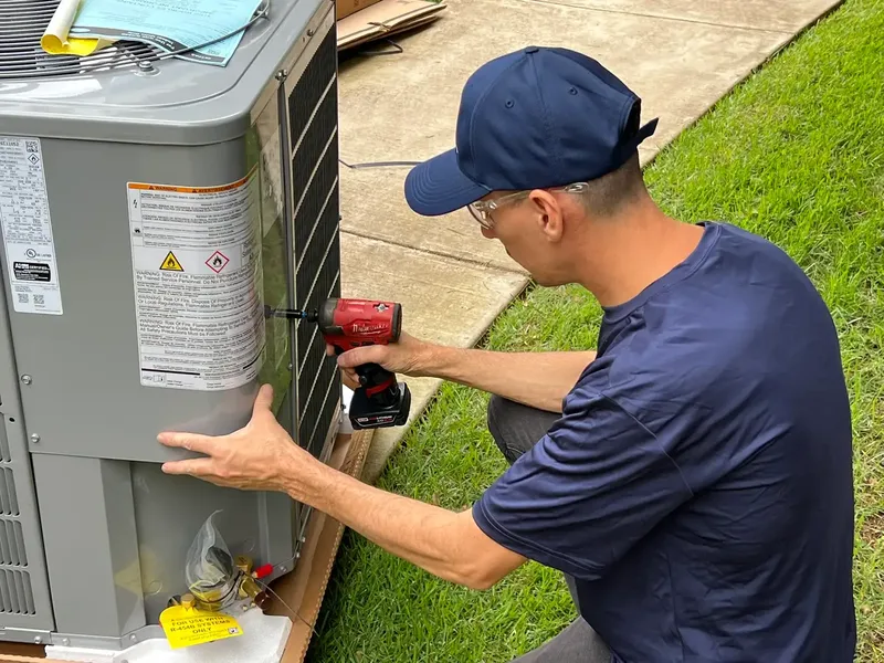 Technician diagnosing residential heat pump system